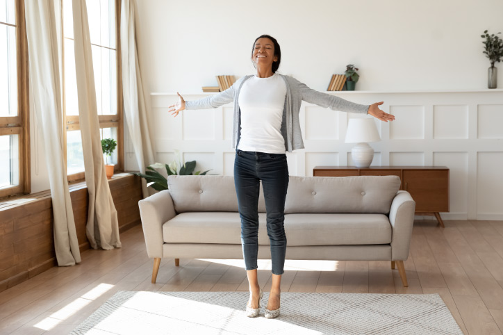 a woman in her living room enjoying her home renovations